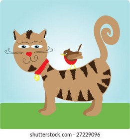Striped cat outside on grass with bird on it's back