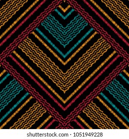 Striped ethnic tapestry seamless pattern. Grunge vector tribal background with embroidery effects. Hatching geometric ornament with colorful stripes, lines, zigzag, shapes. Tribe embroidered texture 