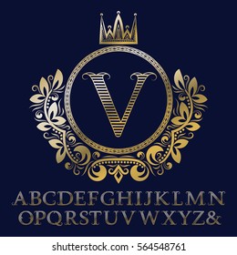 Striped gold letters and initial monogram in coat of arms form with crown. Royal font and elements kit for logo design.