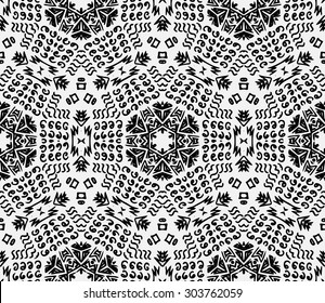 Striped hand painted seamless pattern with ethnic and tribal motifs, zigzag lines, brushstrokes and splatters of paint in black and white colors. Hexagonal motif. Hipster background.