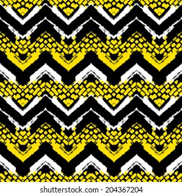 Striped hand painted vector seamless pattern with ethnic and tribal motifs, zigzag lines and brushstrokes in bright yellow, black and white colors for summer fall fashion