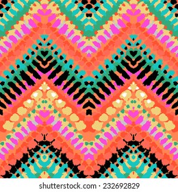 Striped hand painted vector seamless pattern with ethnic and tribal motifs, zigzag lines, brushstrokes and splatters of paint in multiple bright colors for summer fall fashion