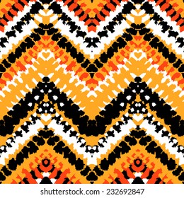 Striped hand painted vector seamless pattern with ethnic and tribal motifs, zigzag lines, brushstrokes and splatters of paint in multiple bright colors for summer fall fashion