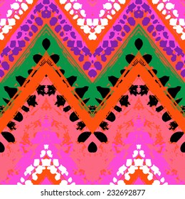 Striped hand painted vector seamless pattern with ethnic and tribal motifs, zigzag lines, brushstrokes and splatters of paint in multiple bright colors for summer fall fashion