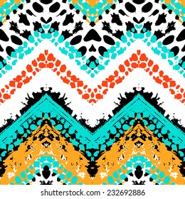 Striped hand painted vector seamless pattern with ethnic and tribal motifs, zigzag lines, brushstrokes and splatters of paint in multiple bright colors for summer fall fashion