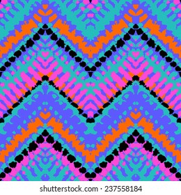 Striped hand painted vector seamless pattern with ethnic and tribal motifs, zigzag lines, brushstrokes and splatters of paint in multiple bright colors for summer fall fashion