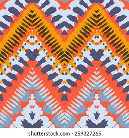 Striped hand painted vector seamless pattern with ethnic and tribal motifs, zigzag lines, brushstrokes and splatters of paint in multiple bright colors for summer fall fashion
