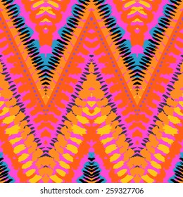 Striped hand painted vector seamless pattern with ethnic and tribal motifs, zigzag lines, brushstrokes and splatters of paint in multiple bright colors for summer fall fashion
