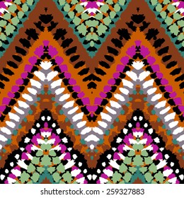 Striped hand painted vector seamless pattern with ethnic and tribal motifs, zigzag lines, brushstrokes and splatters of paint in multiple bright colors for summer fall fashion