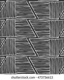 Striped inked rough half hexagons on black.Seamless pattern. Hand drawn seamless background.