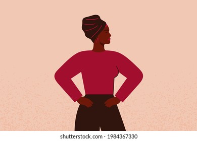 Strong black girl in head scarf with hands on her hips looks forward. Confident Businesswoman or entrepreneur in corporate clothing. Concept of gender equality and of the female empowerment movement.