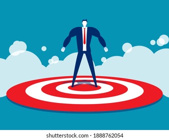 Strong businessman standing on target. Conquer the goal