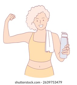 A strong and confident woman is flexing her arm proudly while holding a water bottle after an intense workout session