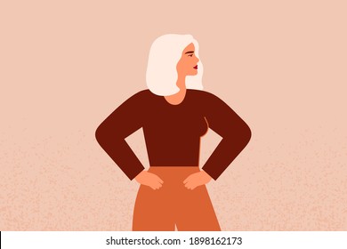 Strong female with hands on her hips looks forward. Confident Businesswoman or entrepreneur in corporate clothing. The concept of gender equality and of the female empowerment movement.