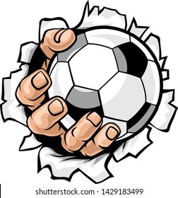 A strong hand holding a soccer football ball tearing through the background. Sports graphic