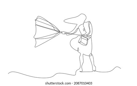strong wind outside it's a cold rainy day and a woman tries to open her umbrella but the umbrella turns upside down
