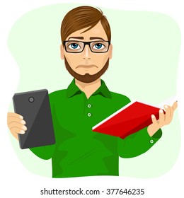 student boy with glasses choosing between tablet and books 