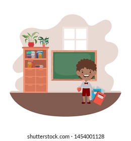 student boy with school supplies in the classroom