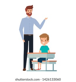 student boy seated in school desk with male teacher