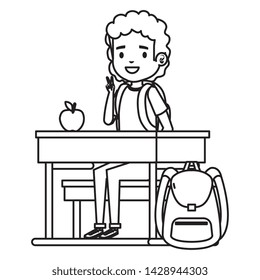 student boy seated in school desk with apple and bag