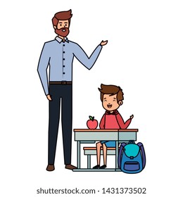 student boy seated in school desk with male teacher