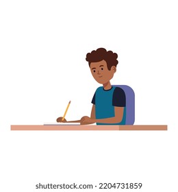 student boy writing in notebook