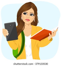 student girl choosing between tablet and books 