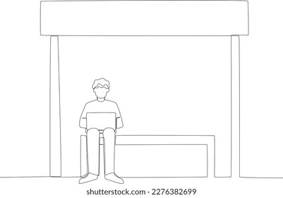 A student sits at a bus stop while opening a laptop. Public transport one-line drawing