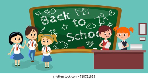 students engaged in classoom, boy and girl at table near blackboard holding papers in their hands and doing homework, listening to the tasks in the headphones