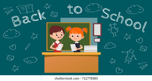 students engaged in classoom, boy and girl at table near blackboard holding papers in their hands and doing homework, listening to the tasks in the headphones