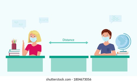 Students in medical masks sit at their desks in school. There is a  Safe distance between them. Safe education concept