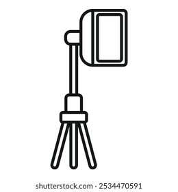 Studio spotlight standing on a tripod, providing professional lighting for photography or videography