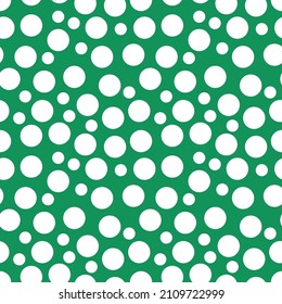 Stunning, trendy seamless pattern of white balls in a simple flat style on a green background. For children s clothing, fashionable fabrics, home decor, backgrounds, postcards and templates, packaging