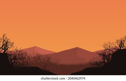 Stunning views of the mountains with dry tree silhouettes from the edge of the city at dusk. Vector illustration of a city