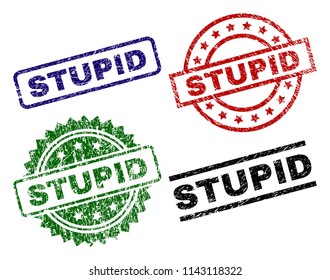 STUPID seal stamps with damaged surface. Black, green,red,blue vector rubber prints of STUPID label with grunge surface. Rubber seals with round, rectangle, medallion shapes.