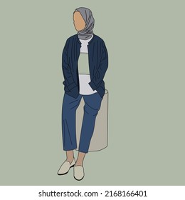 The style of women in dark blue jeans, inner white undershirts with green accents, denim jeans, equipped with a light-colored hijab, and cream-colored shoes