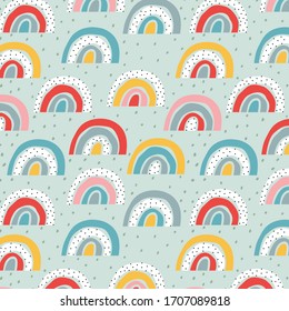Stylised rainbow pattern. Trendy childish vector design for wallpapers, cards, wrapping paper. Dots and rainbows vector nursery texture. Soft pastel colour hand-drawn pattern.
