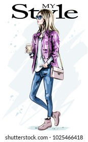 Stylish beautiful young woman with coffee mug. Hand drawn fashion woman. Cute girl with blond hair. Sketch.