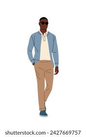 Stylish black man walking in smart casual outfit.