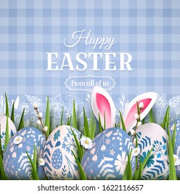 Stylish Easter background with blue and white eggs with floral pattern and bunny ears in the grass.