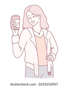 A stylish and fashionable woman, radiantly happy, is joyfully holding a coffee cup in a relaxed, cozy setting