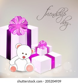 Stylish gift boxes wrapped in purple ribbon and teddy bear on grey background for Happy Friendship Day celebrations. 