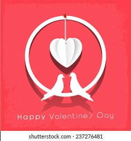 Stylish gift with love birds and hanging heart on red background for Happy Valentine's Day celebration.