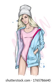 Stylish girl with long hair in a beautiful sports swimsuit, jacket and hat. Beautiful girl. Fashionista. Fashion and style, clothes and accessories. Vector illustration for greeting card or poster.