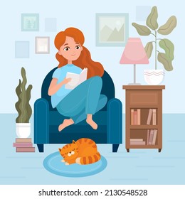 Stylish girl sitting and reading book on armchair at home