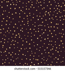 Stylish golden glitter triangles on black seamless vector pattern. Shining gold shimmer simple and funky design print.
