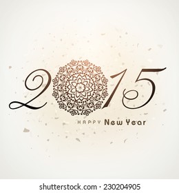 Stylish golden text 2015 with floral design decorated Christmas ball on brown background for Happy New Year celebrations.