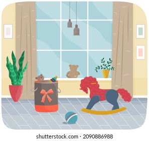El diseño interior de la habitación infantil es elegante. Caballo de juguete con piedras cerca de una canasta con juguetes, pelota y una gran ventana. El interior de la habitación con un mobiliario acogedor. Disposición de mobiliario y decoración en el apartamento