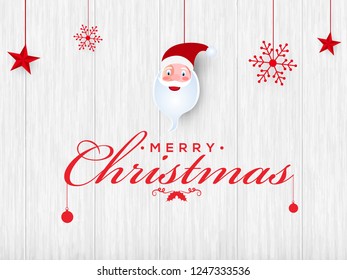 Stylish lettering of Merry Christmas on wooden texture background decorated with festival elements. Can be used as poster or greeting card design.