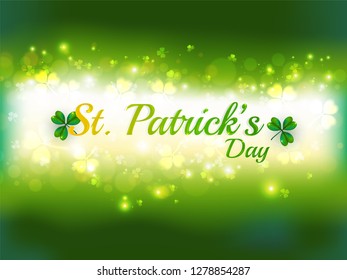Stylish lettering of St. Patrick's Day on shiny clove leaves decorated green background. Banner or poster design.